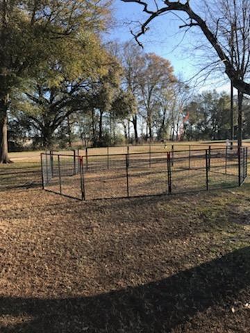 A complete modular hog trap corral assembled and set in a field
